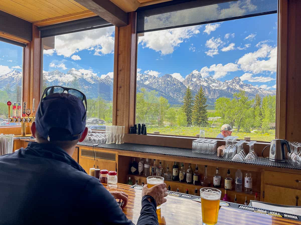 Mike sitting at a bar with a few of the mountains.