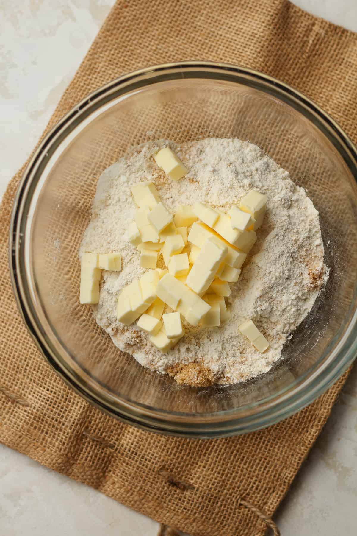 A bowl of the topping mixture with cubed butter.