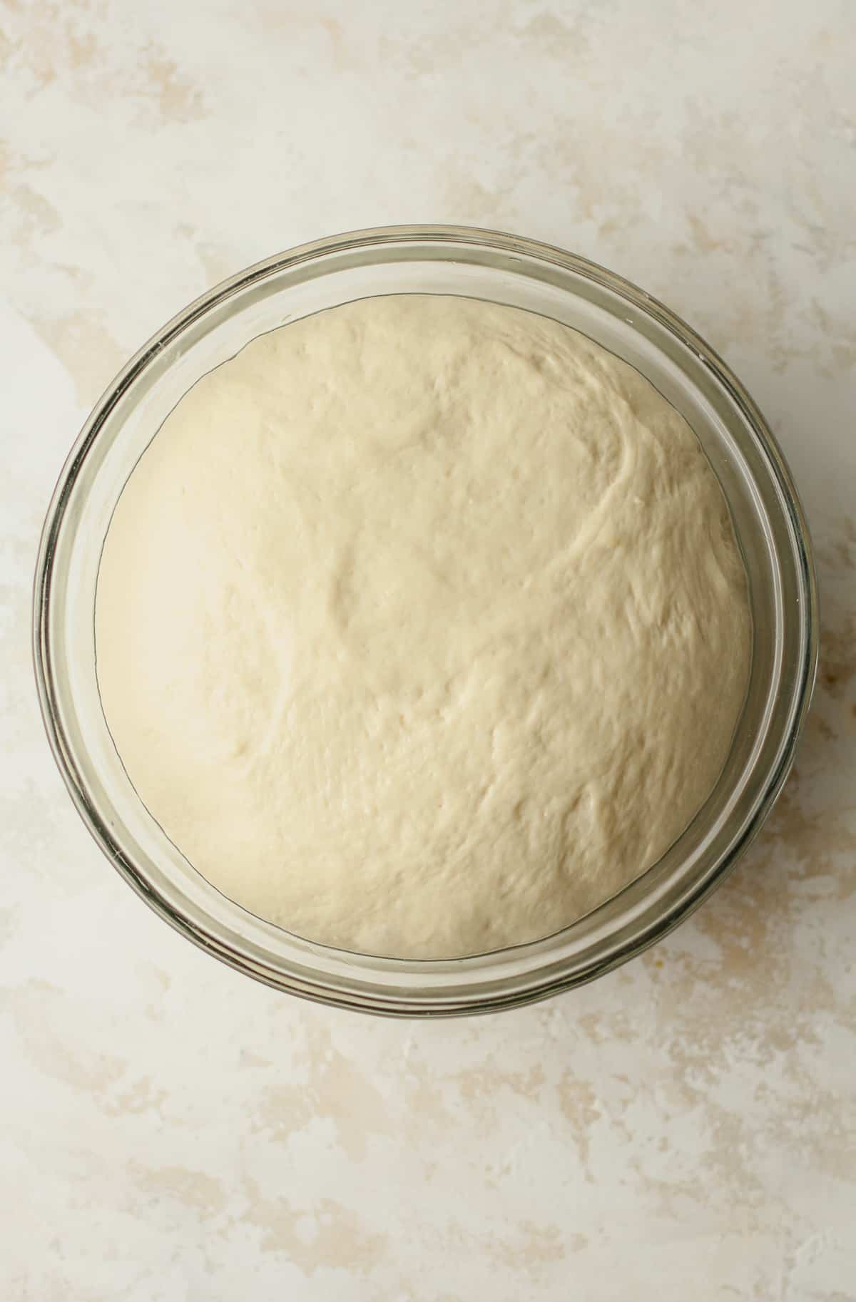 A bowl of the naan bread dough after rising.