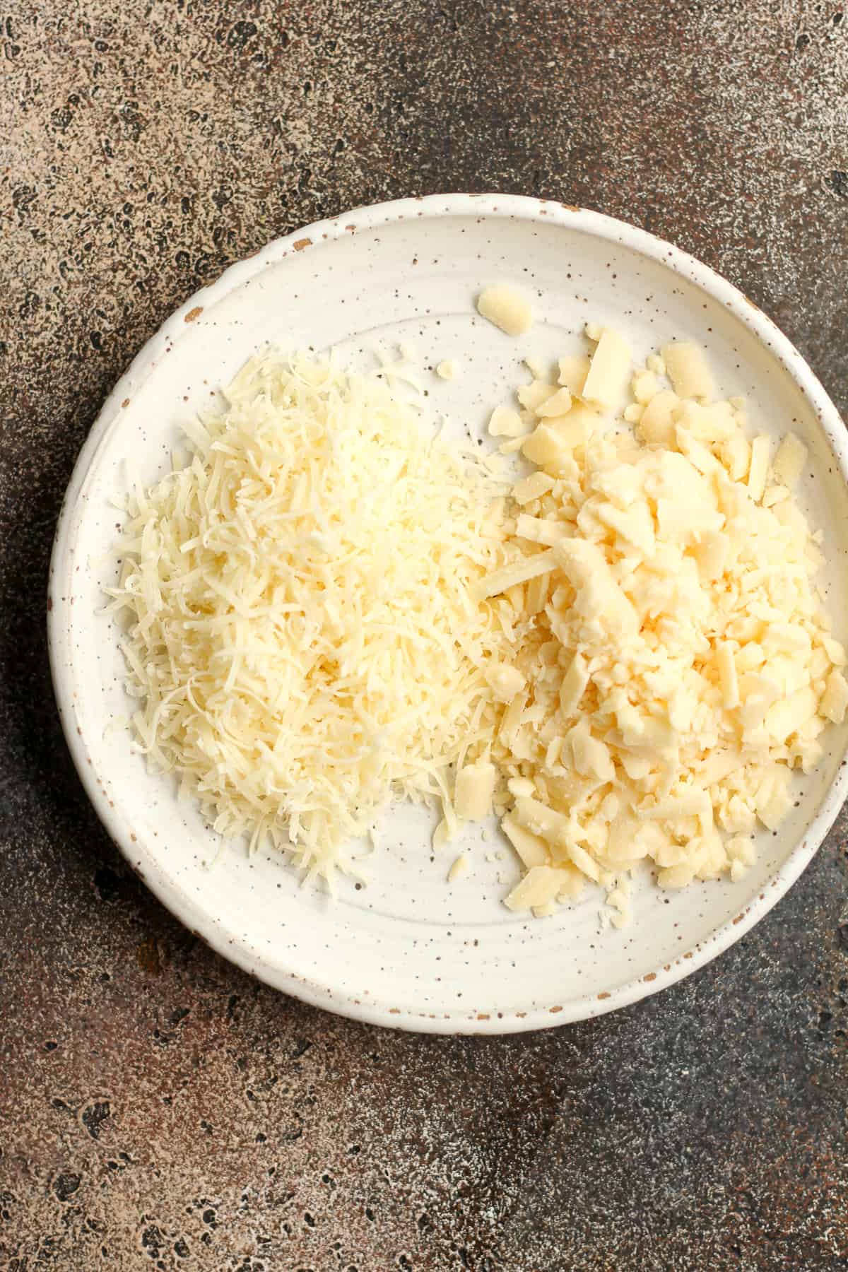 A plate of the parmesan and white cheddar cheese.