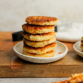 A plate of stacked cheesy potato pancakes.
