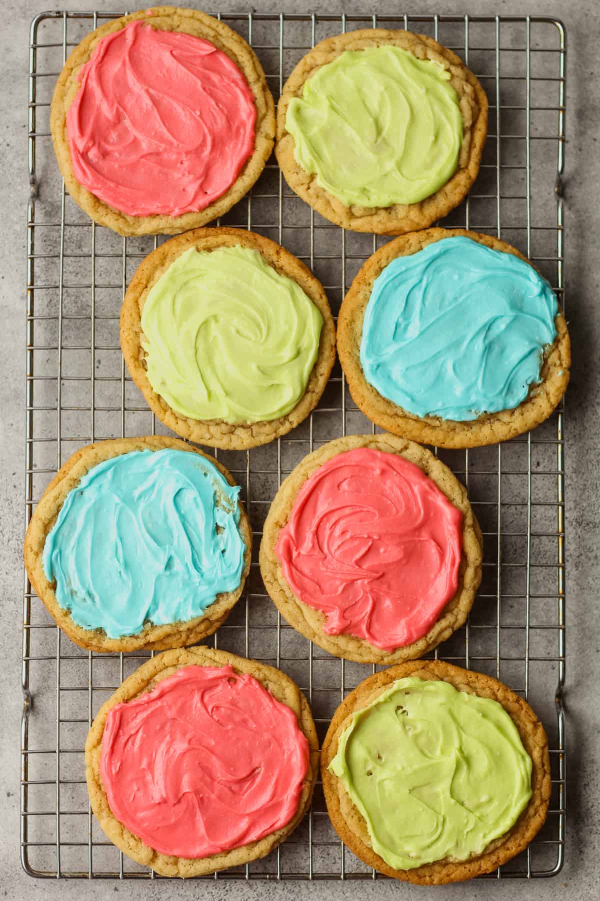 Overhead view of 8 sugar cookies with icing.
