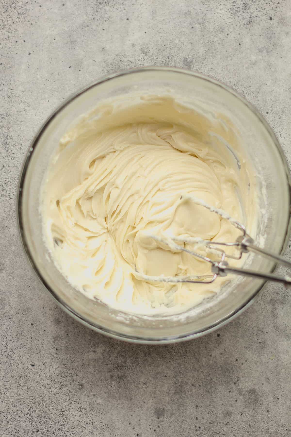 A bowl of powdered sugar frosting.