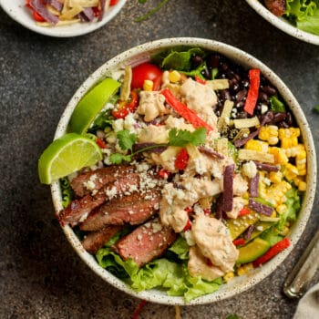 A bowl of steak fajita salad with chipotle ranch.