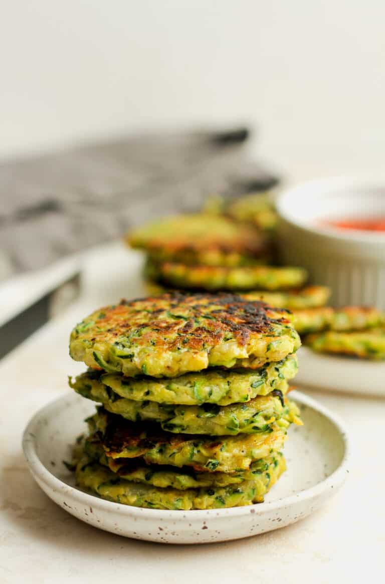 A small plate of stacked zucchini fritters.