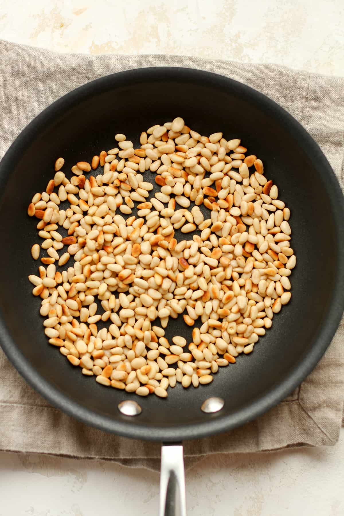 A pan of toasted pine nuts.