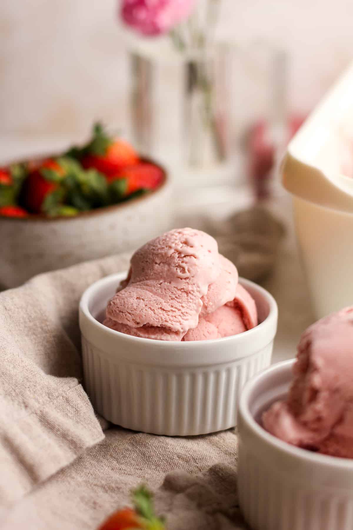 Side view of bowls of strawberry ice cream.