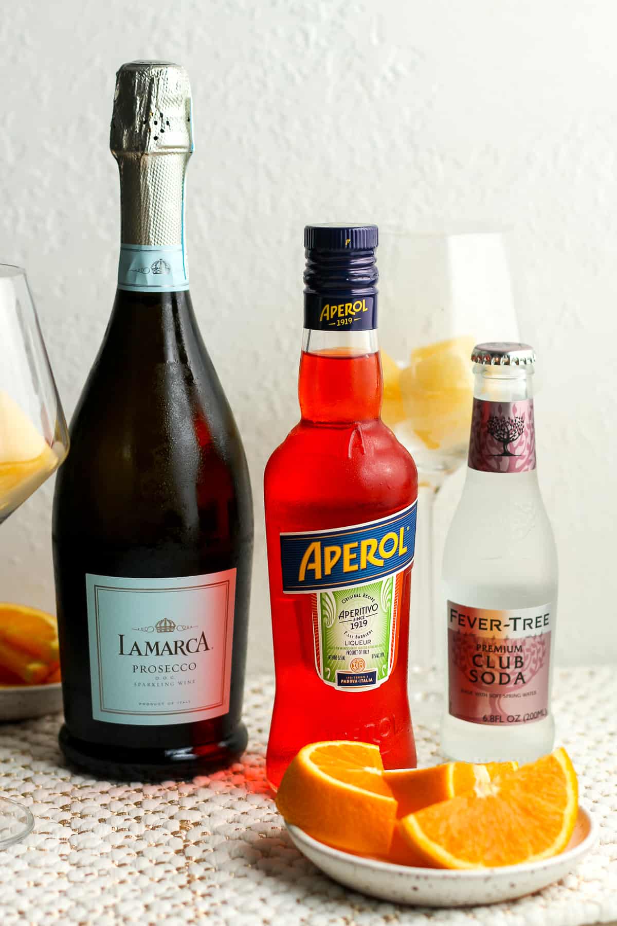 Side view of the ingredients for the aperol spritz.