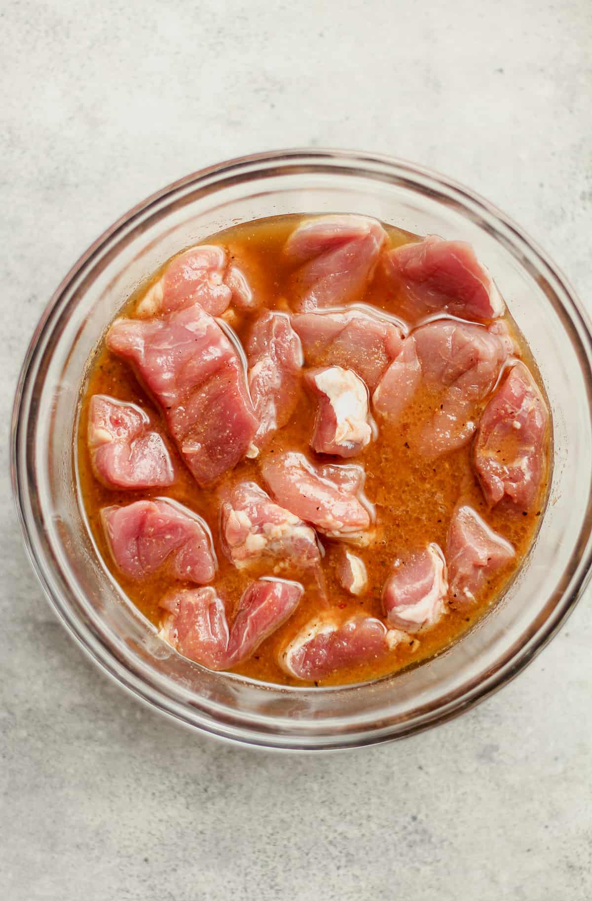 A bowl of the pork pieces in the marinade.