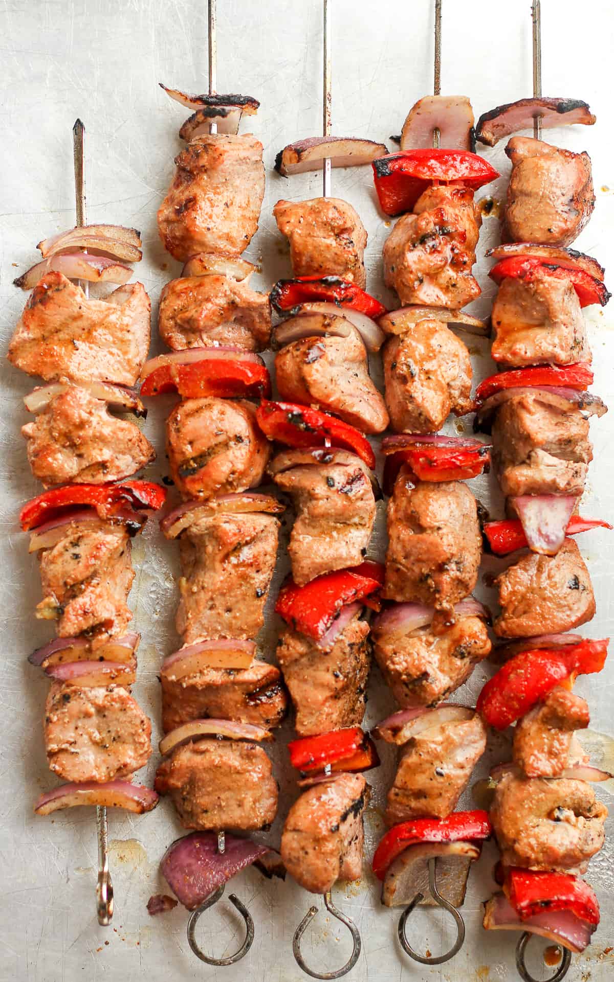 The grilled pork kabobs with peppers and onions.