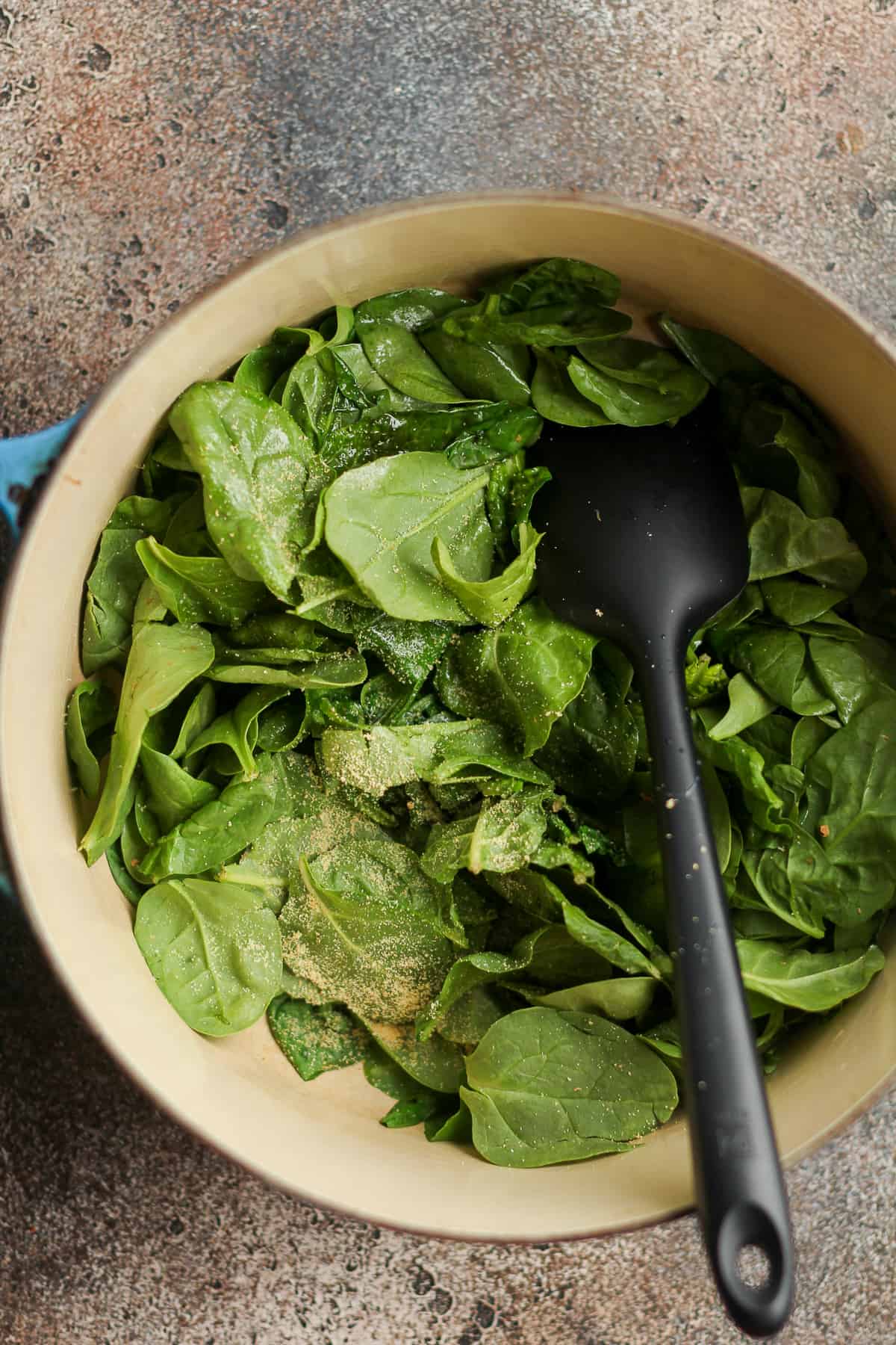 A pot of the spinach cooking.