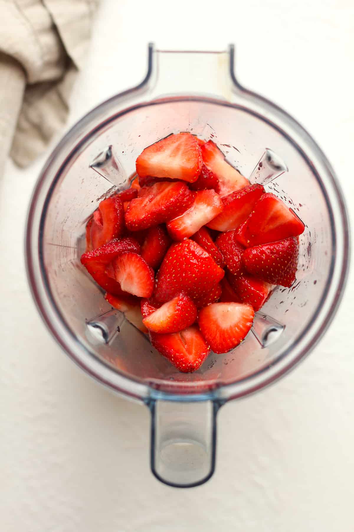 A blender of the sliced strawberries with sugar.