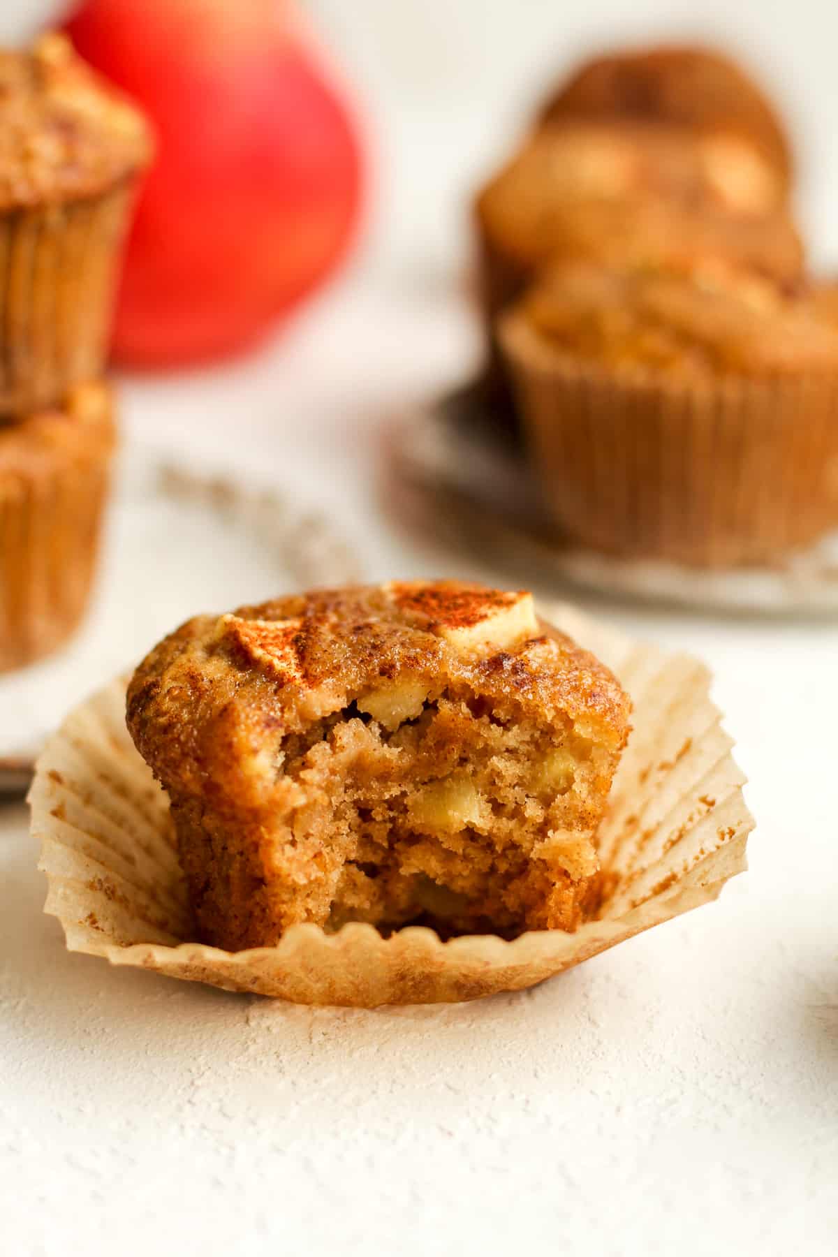 Side view of a partially eaten apple muffin.