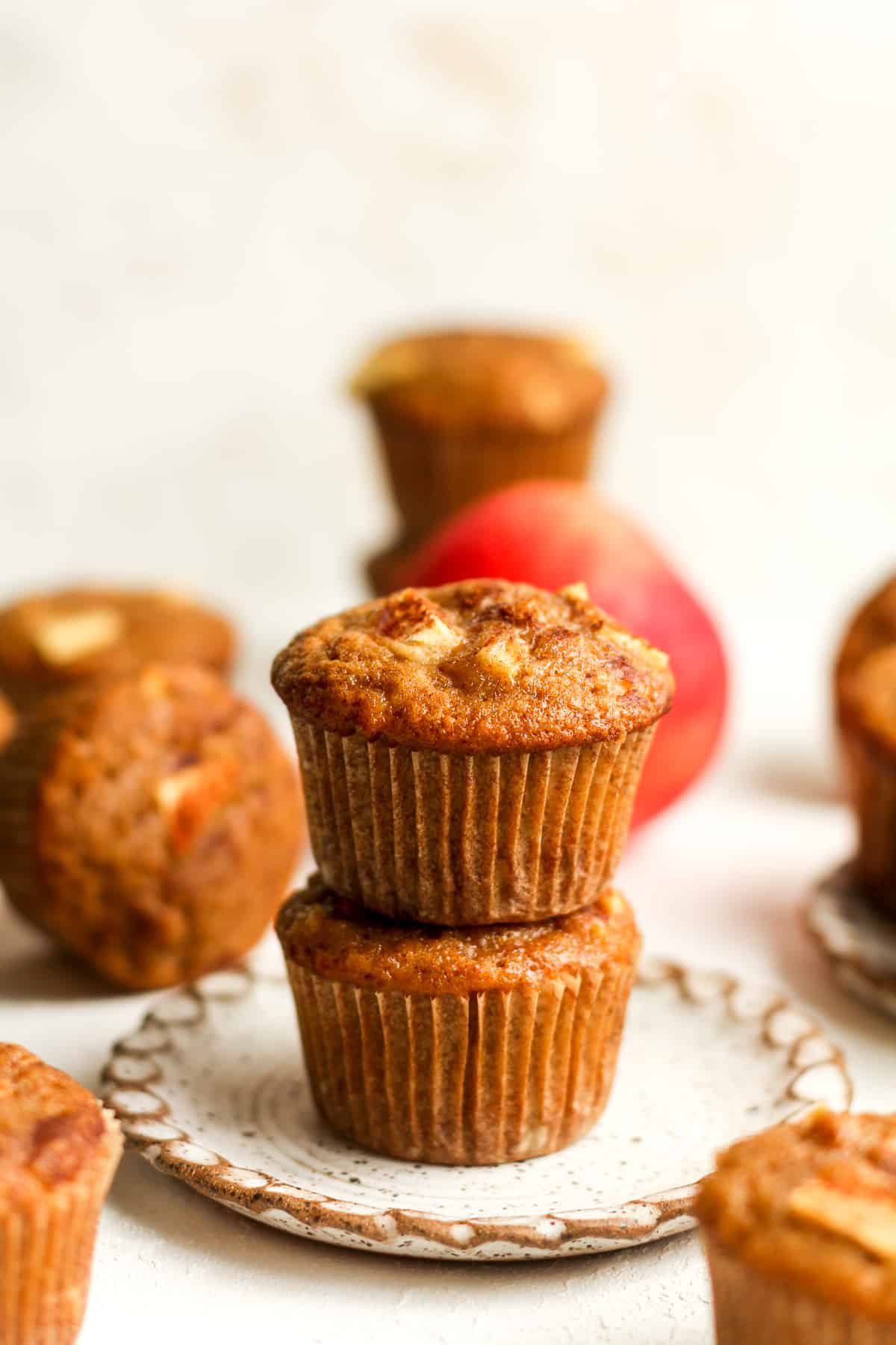 Side view of two stacked apple cinnamon muffins.