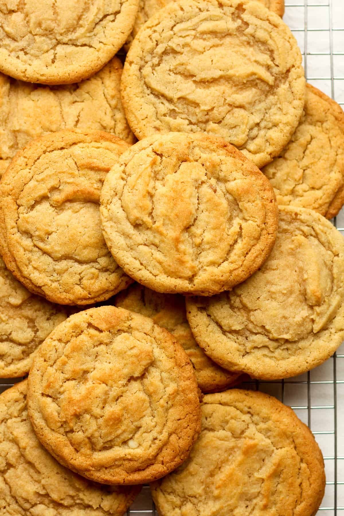 Closeup on some stacked sugar cookies on a cookie rack.