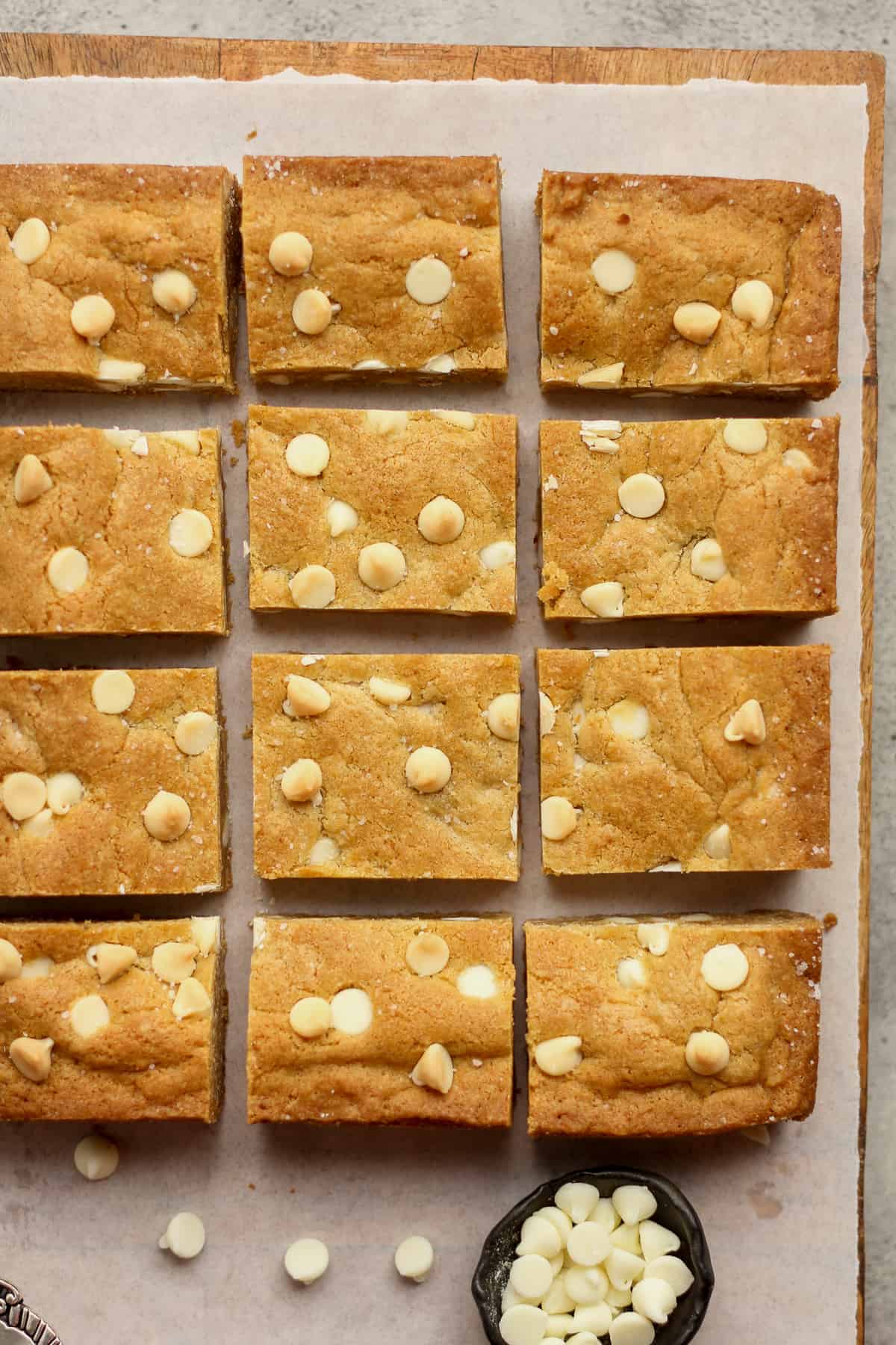Overhead view of 12 sliced blondies with white chocolate chips.