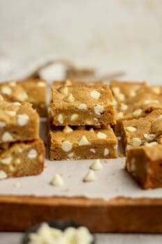 A side shot of a bunch of white chocolate blondies made with brown butter.
