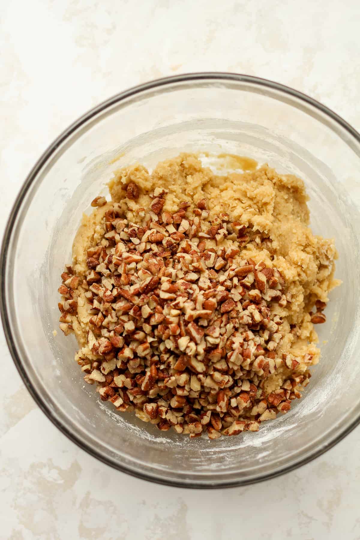 The cookie dough with the chopped pecans on top.