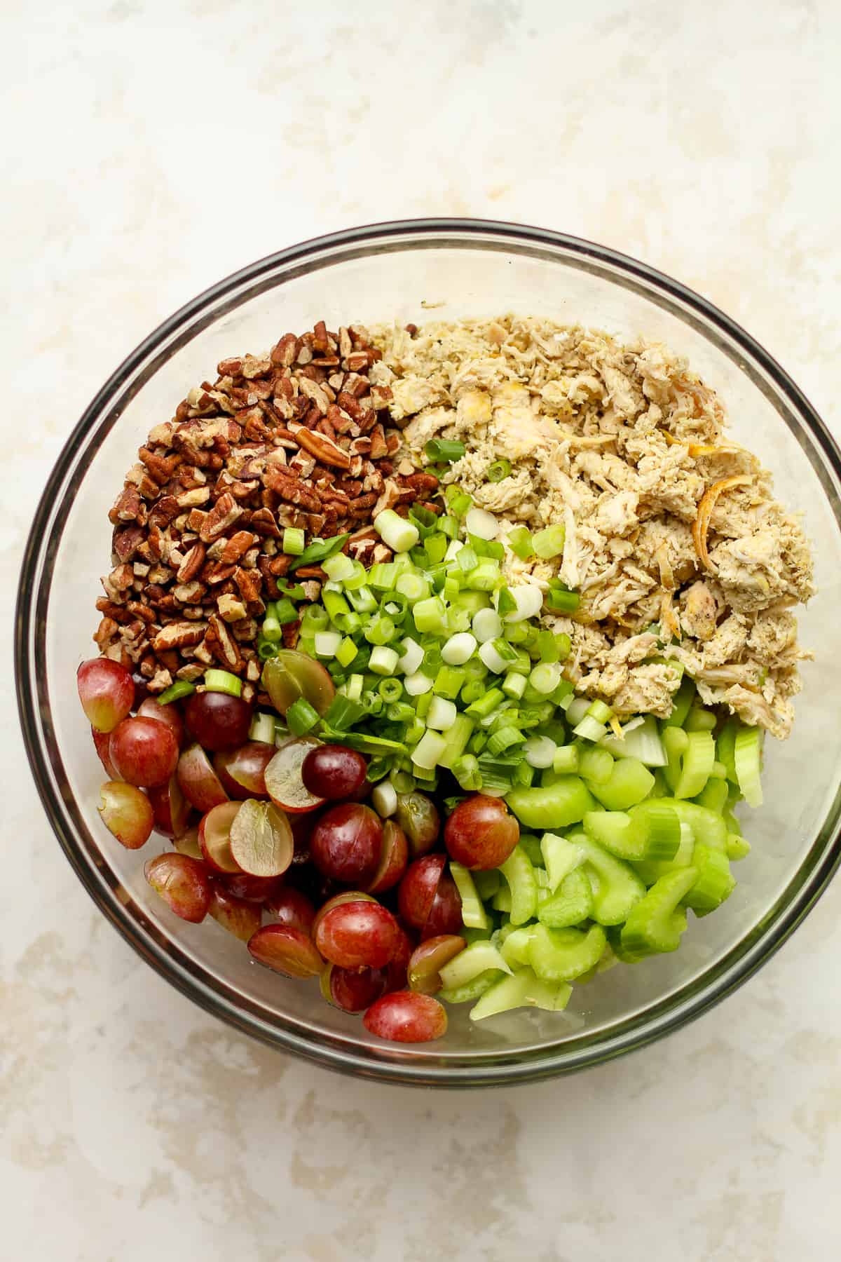 A bow of the chicken salad ingredients by ingredient.
