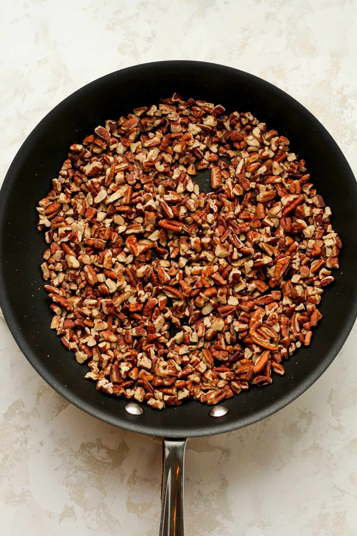 A pan of chopped toasted pecans.