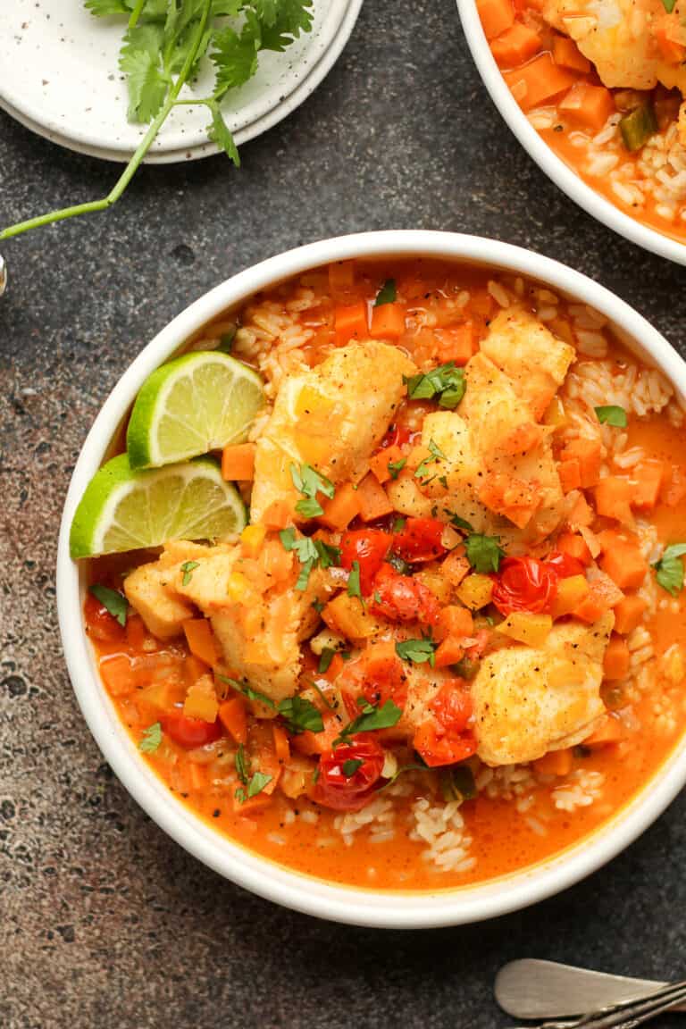 A bowl of curry fish stew in a white bowl.