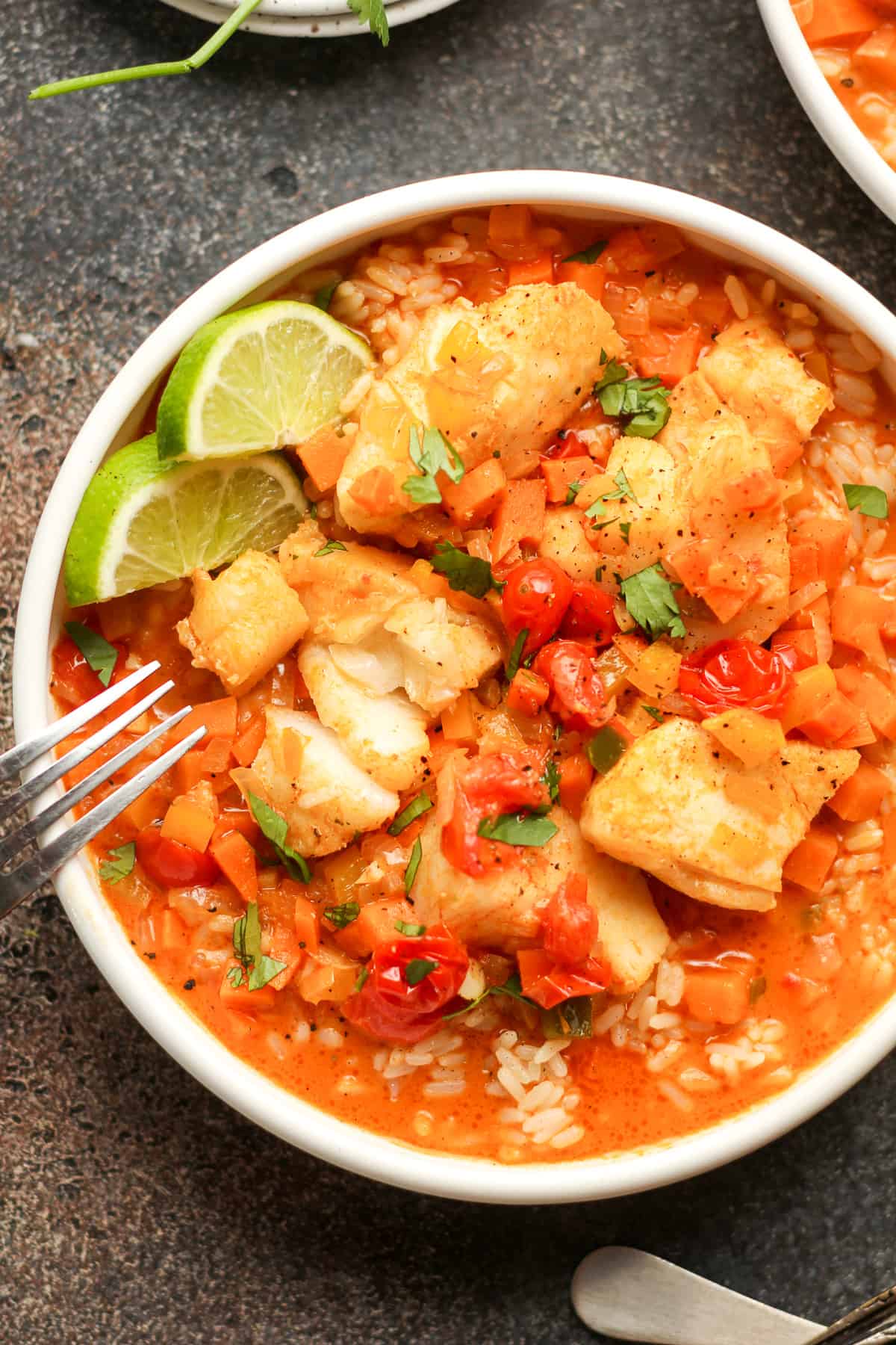 Closeup on a bowl of curry fish stew with veggies.