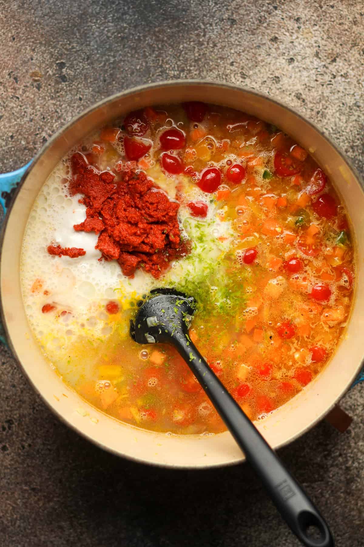 A pot of the stew ingredients after adding the chili paste.