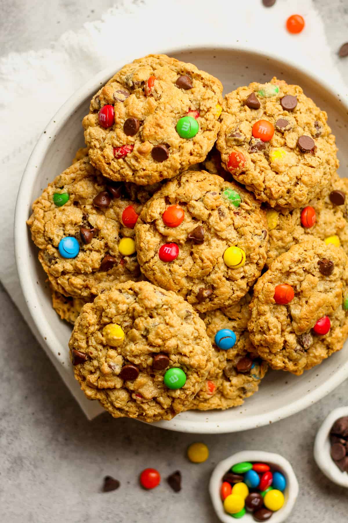 A bowl of monster cookies with m&ms and chocolate chips.