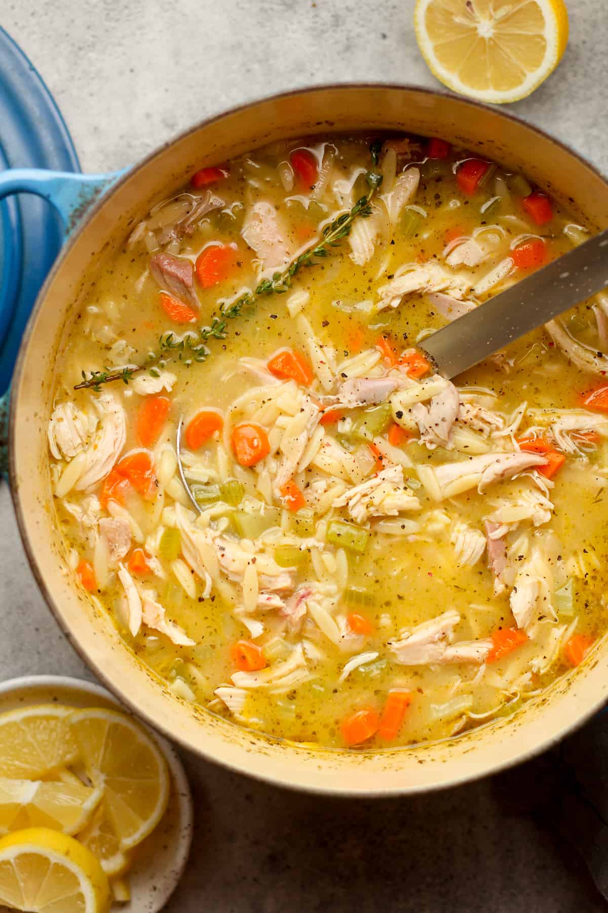 A stock pot of the chicken soup with orzo and lemon.