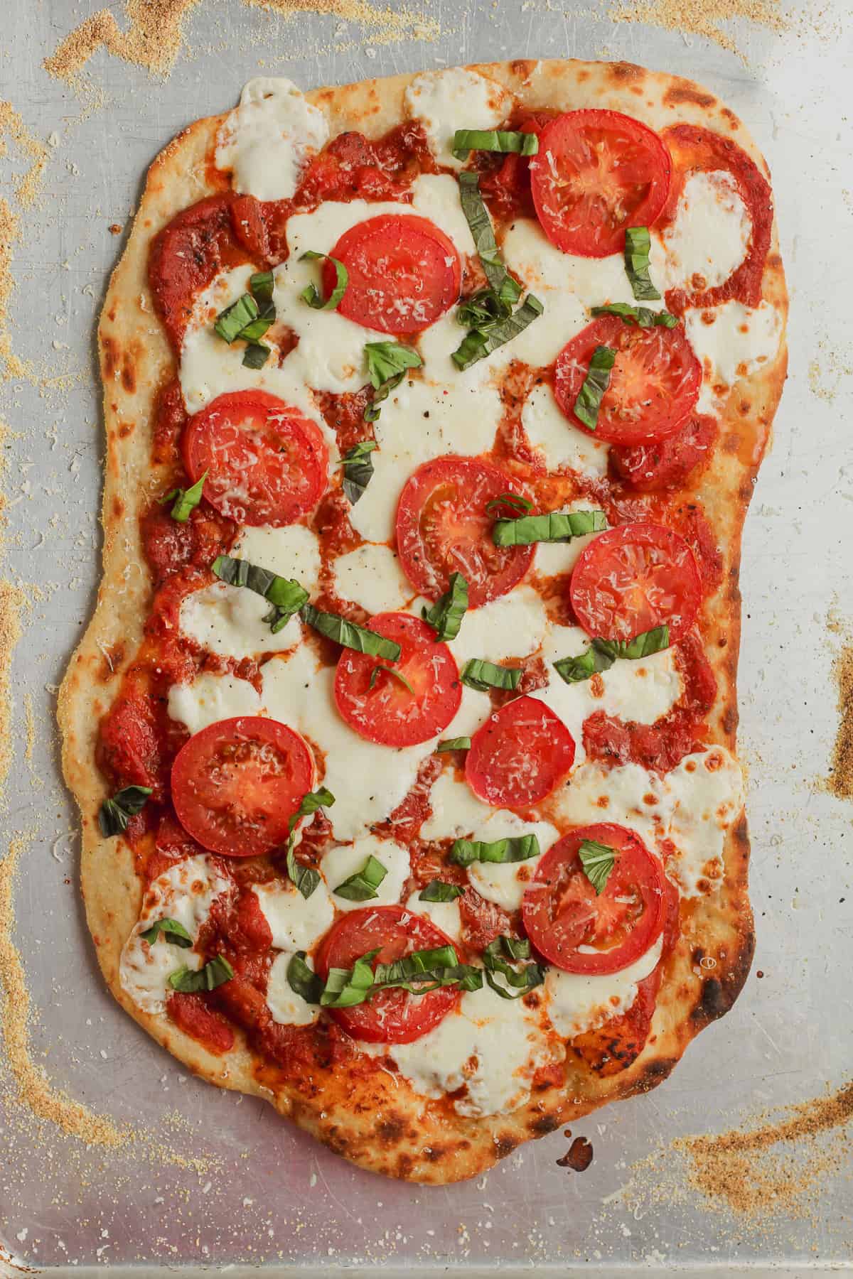 A pan of just baked flatbread pizza.