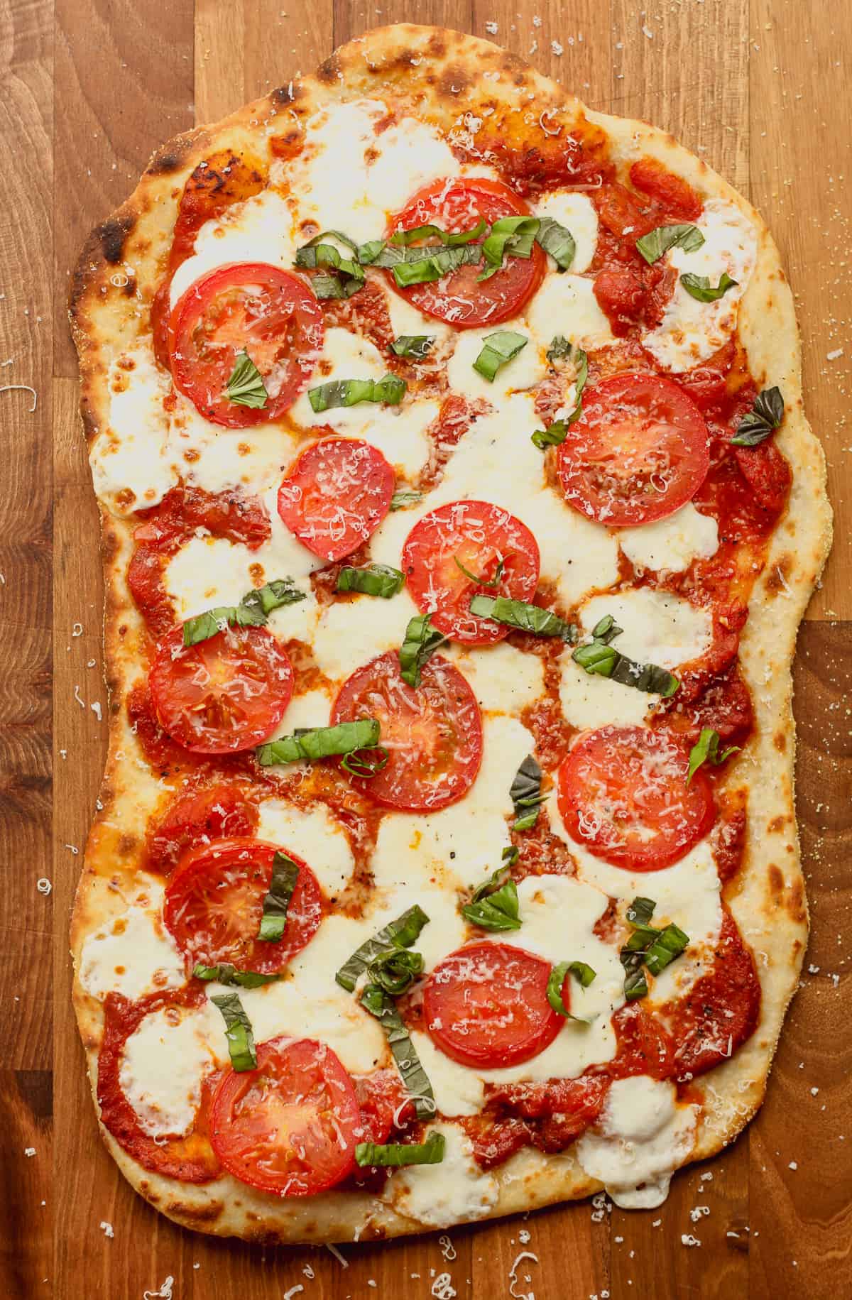 A margherita flatbread pizza just out of the oven.