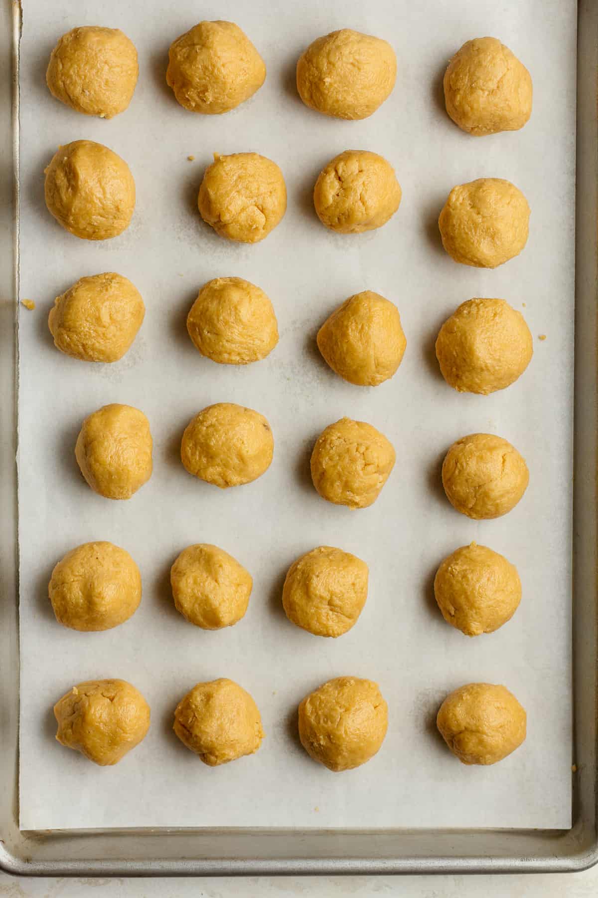 A pan of 24 peanut butter cookie balls.