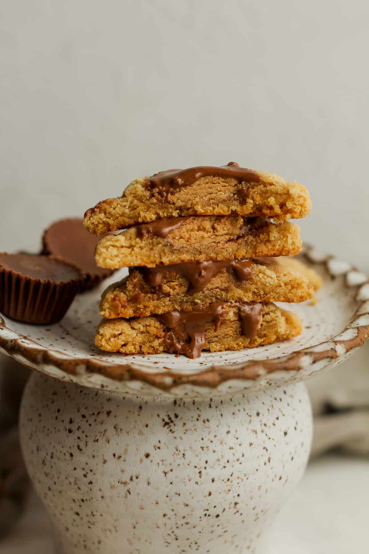a small plate of halved peanut butter cup cookies stacked up.