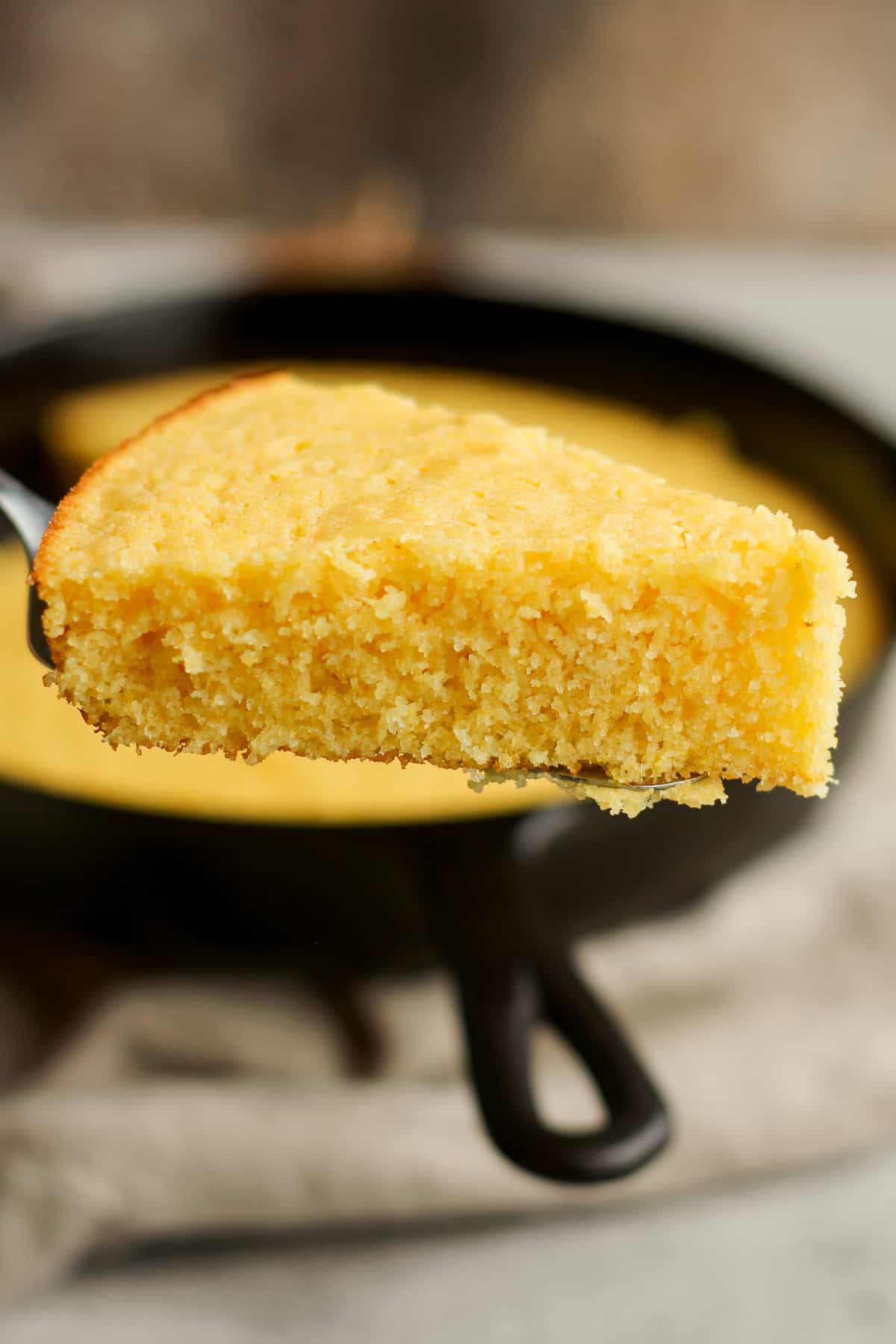 Side view of a slice of just baked cornbread.
