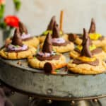A silver tray of peanut butter witch hat cookies.