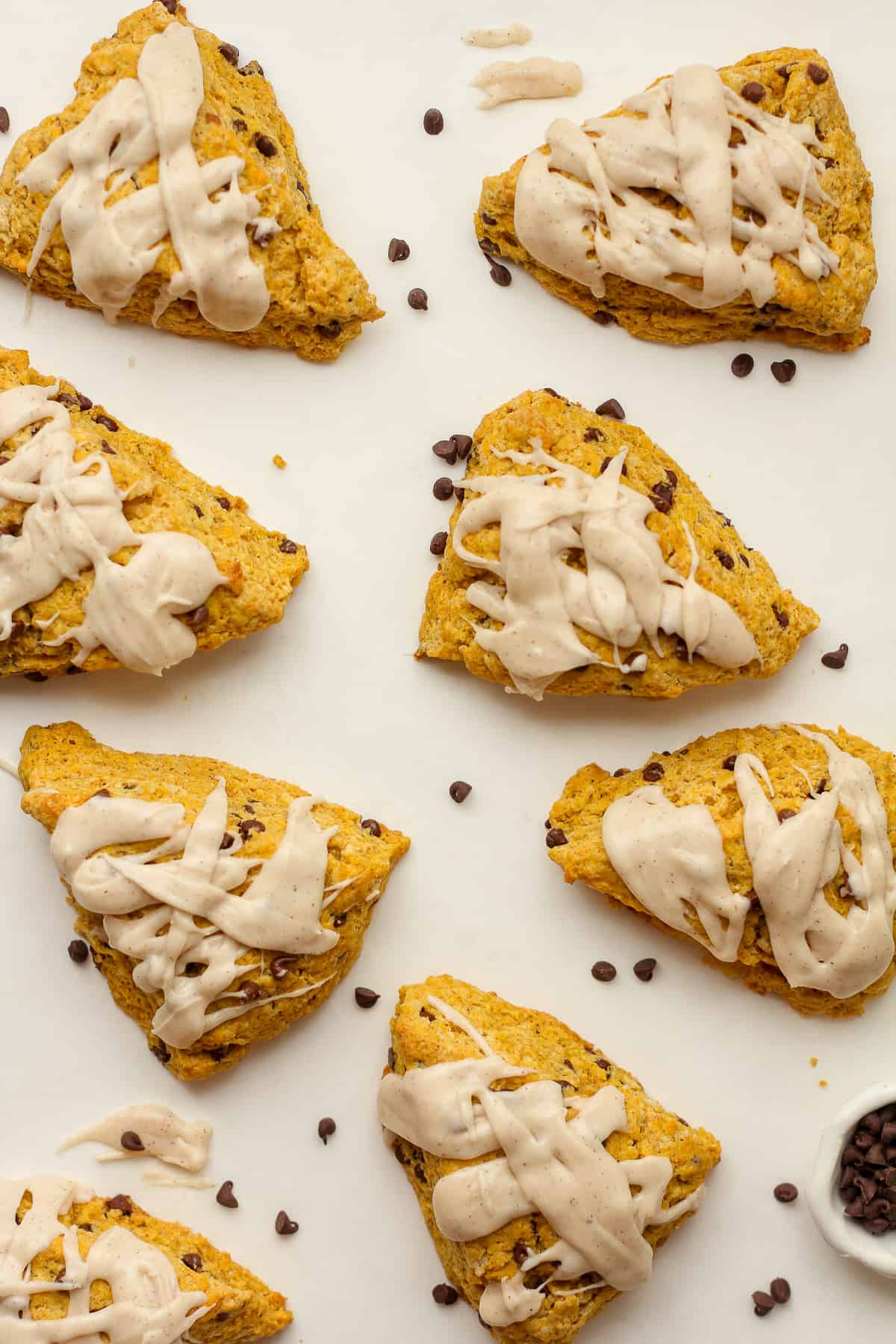 Eight frosted pumpkin scones.