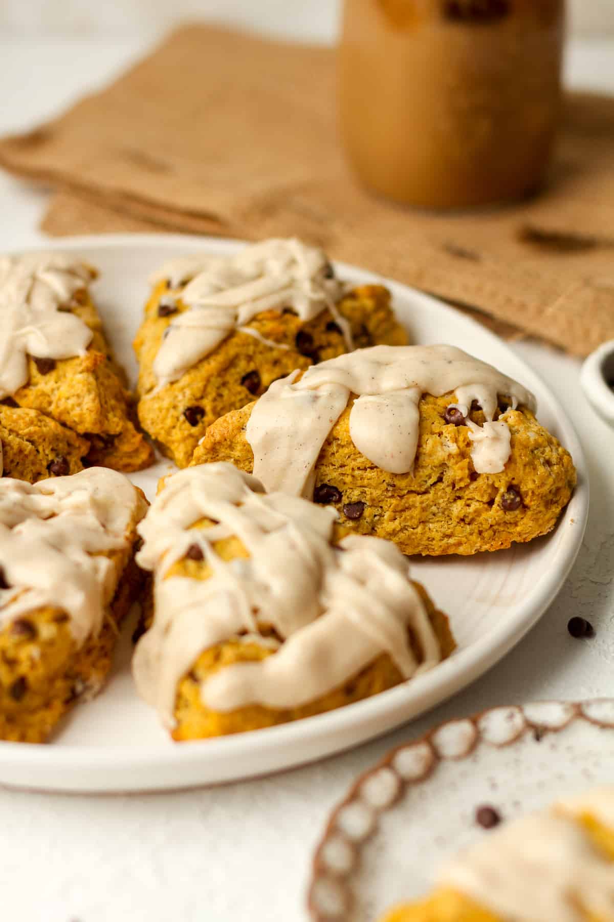 Side view of pumpkin spice scones with an ice coffee.