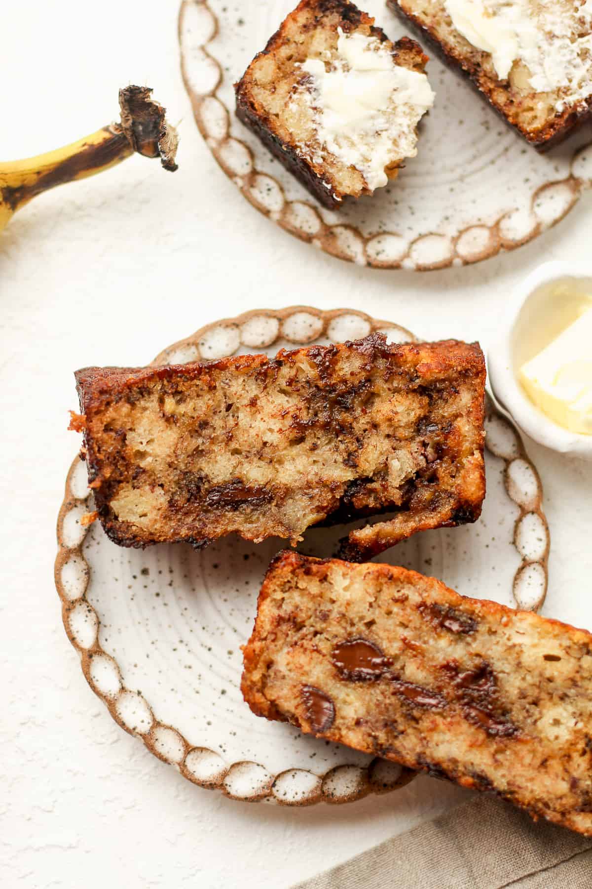 Two plates of the best banana bread, one with chocolate chips.