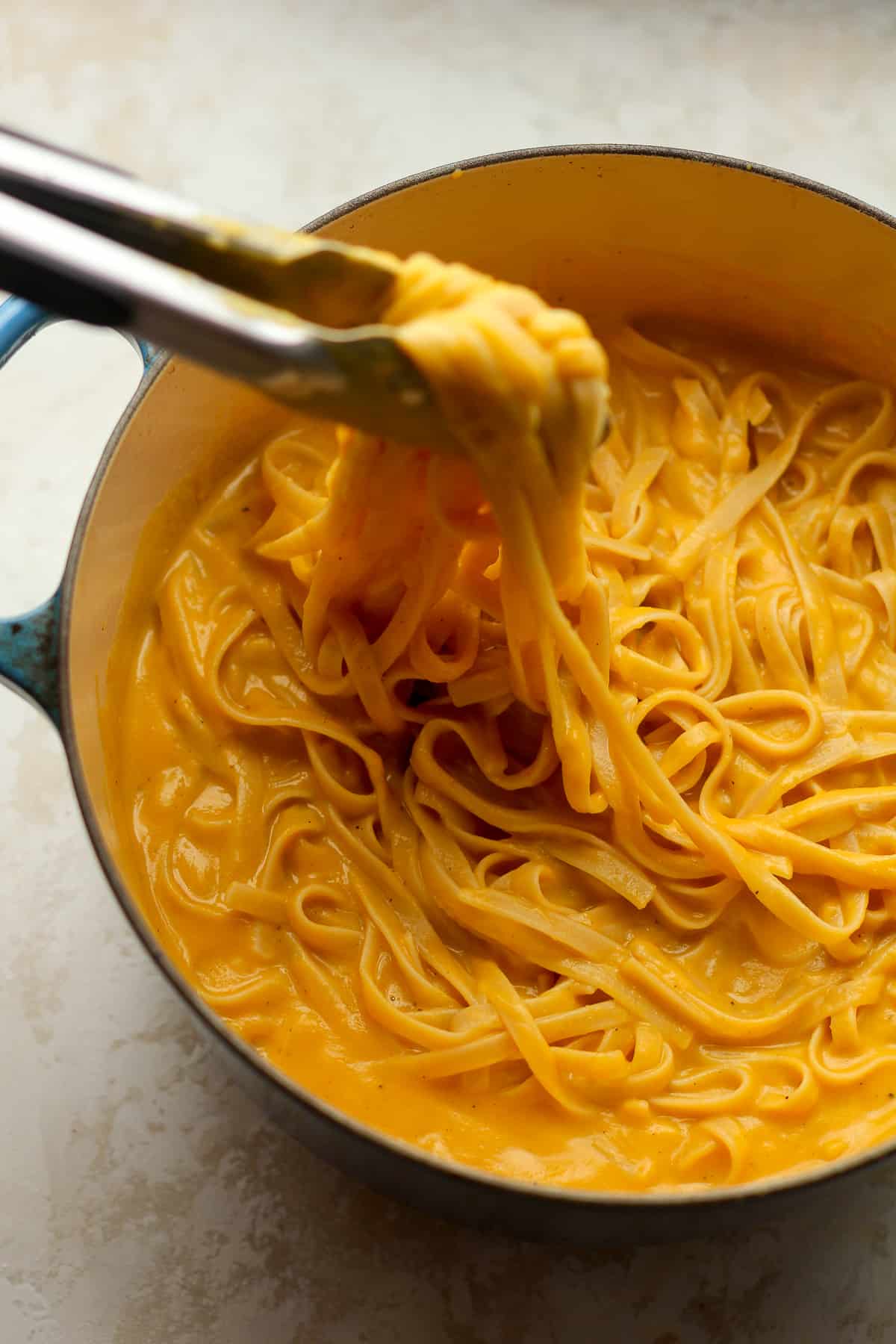 A stock pot full of creamy butternut squash pasta.