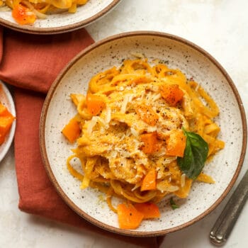A bowl of roasted butternut squash pasta with chunks of squash.
