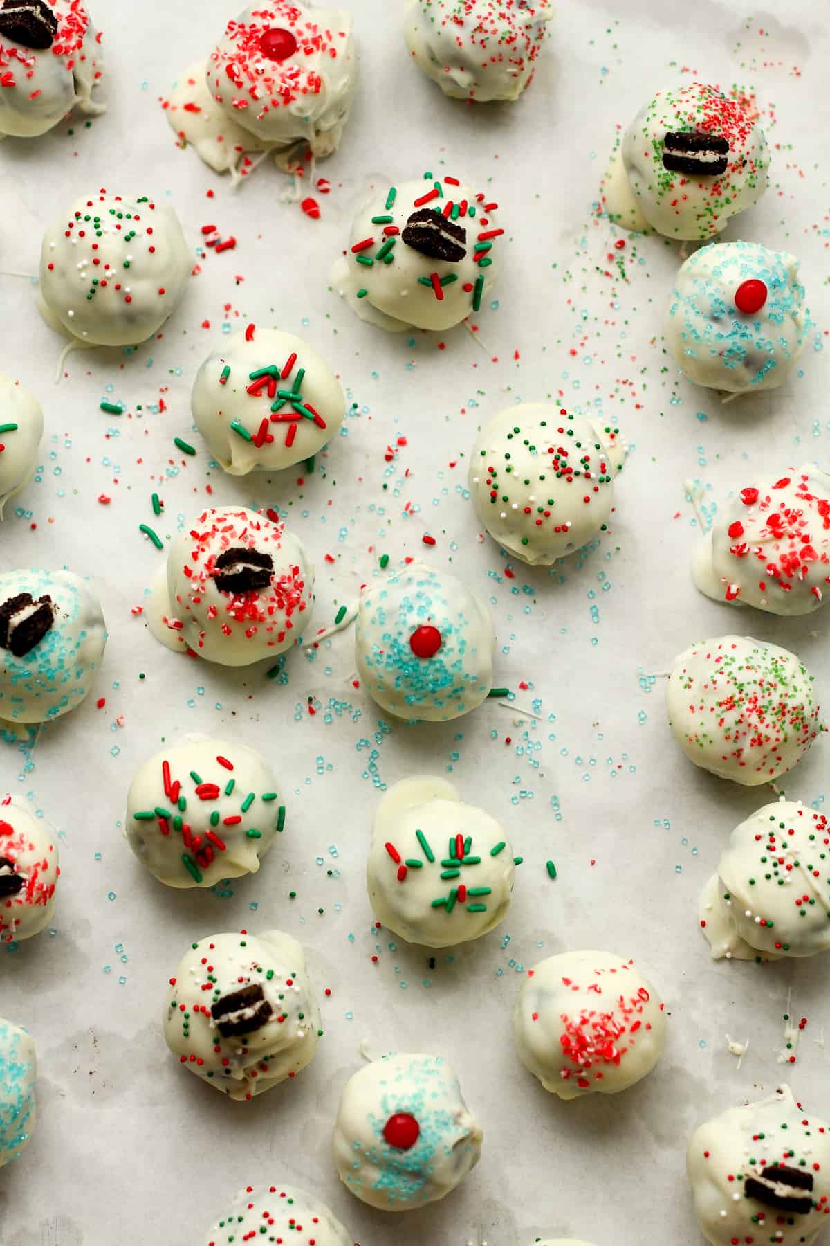 A sheet pan of decorated Oreo truffles.