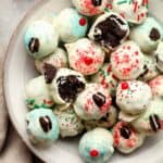 A bowl of white chocolate oreo truffles with sprinkles.