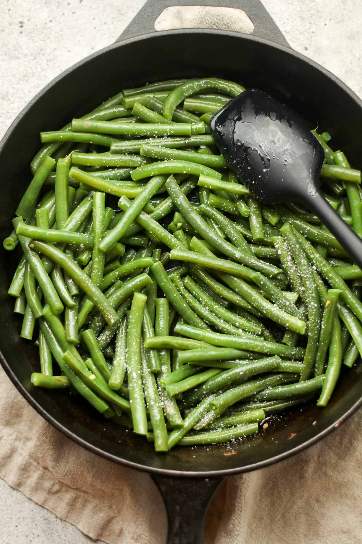 The green beans in a cast iron skillet.
