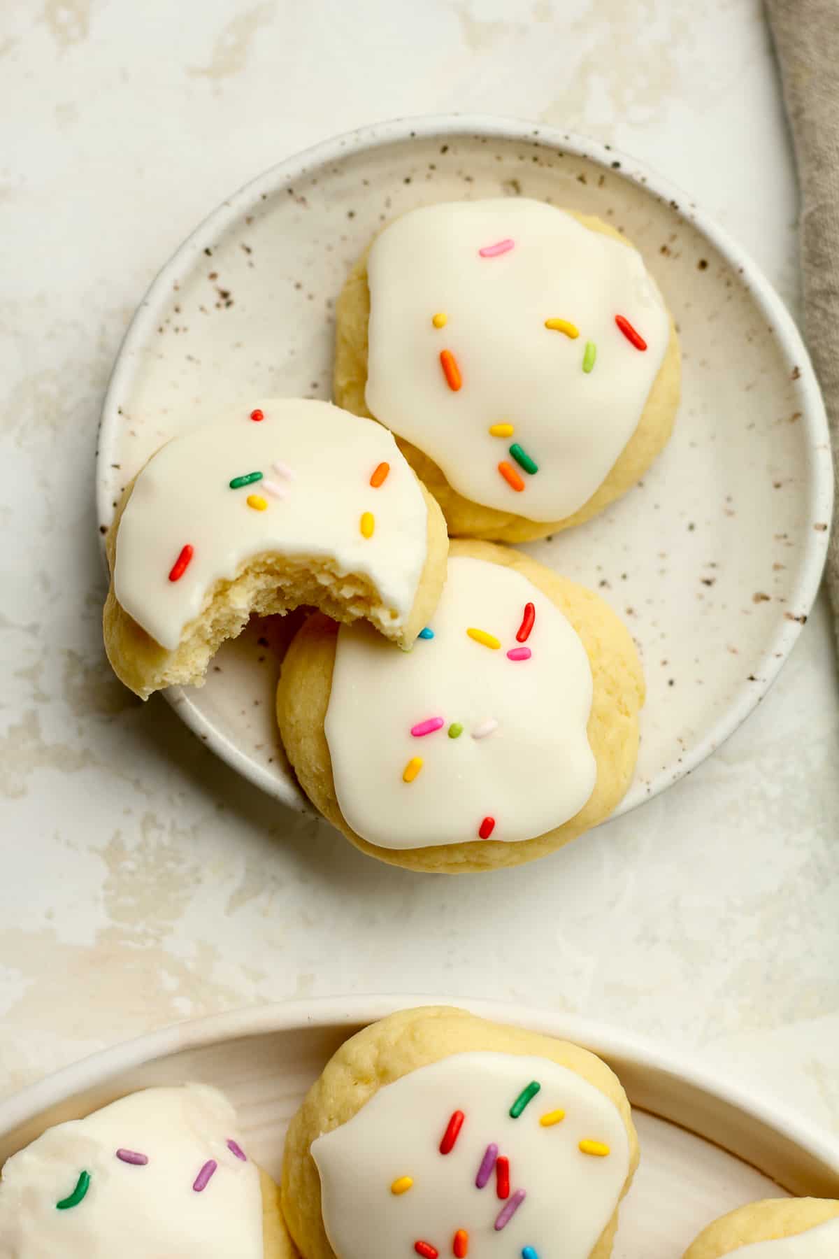A small plate of lemon ricotta cookies with sprinkles.