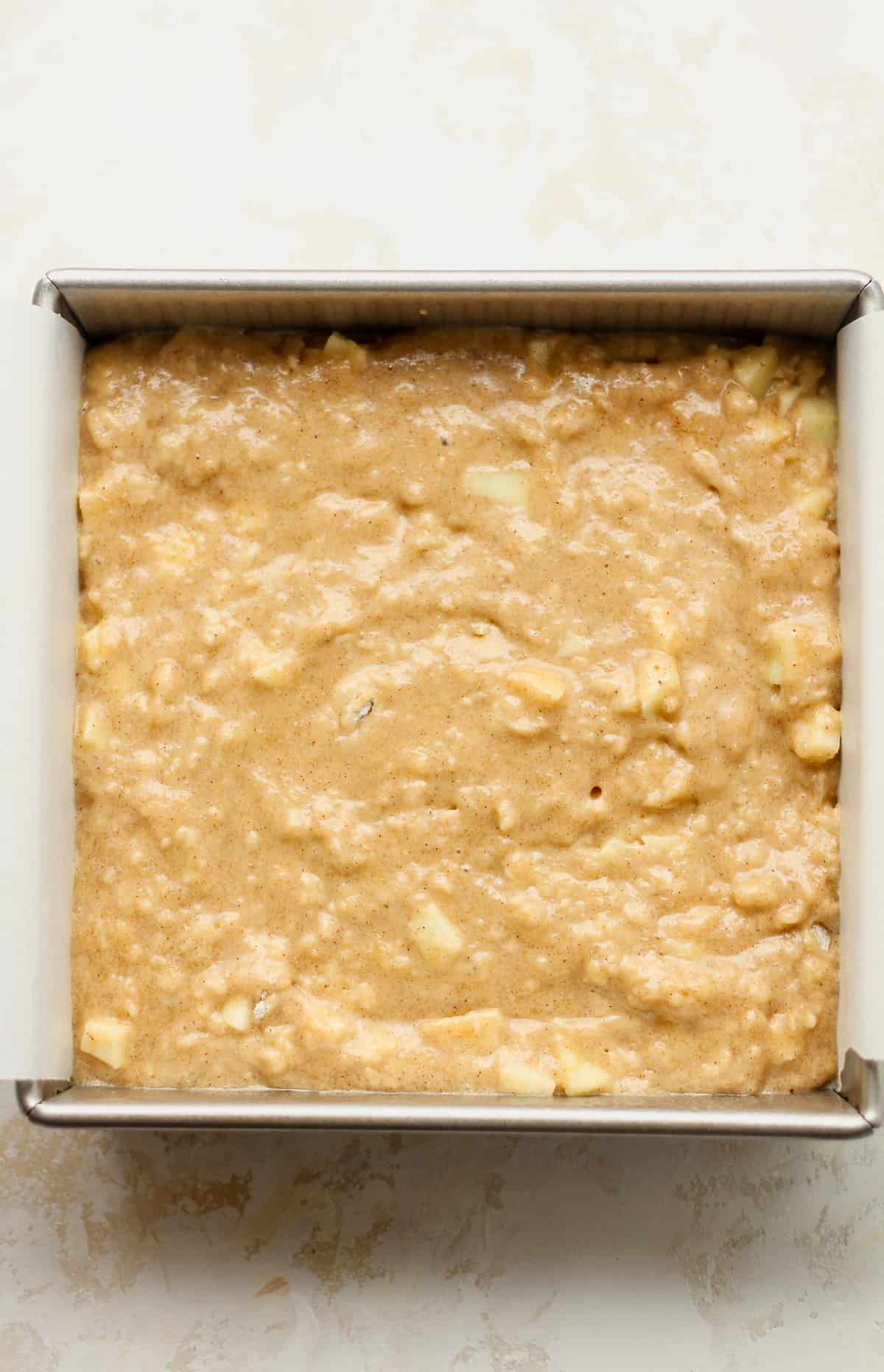 A square pan of applesauce cake batter.