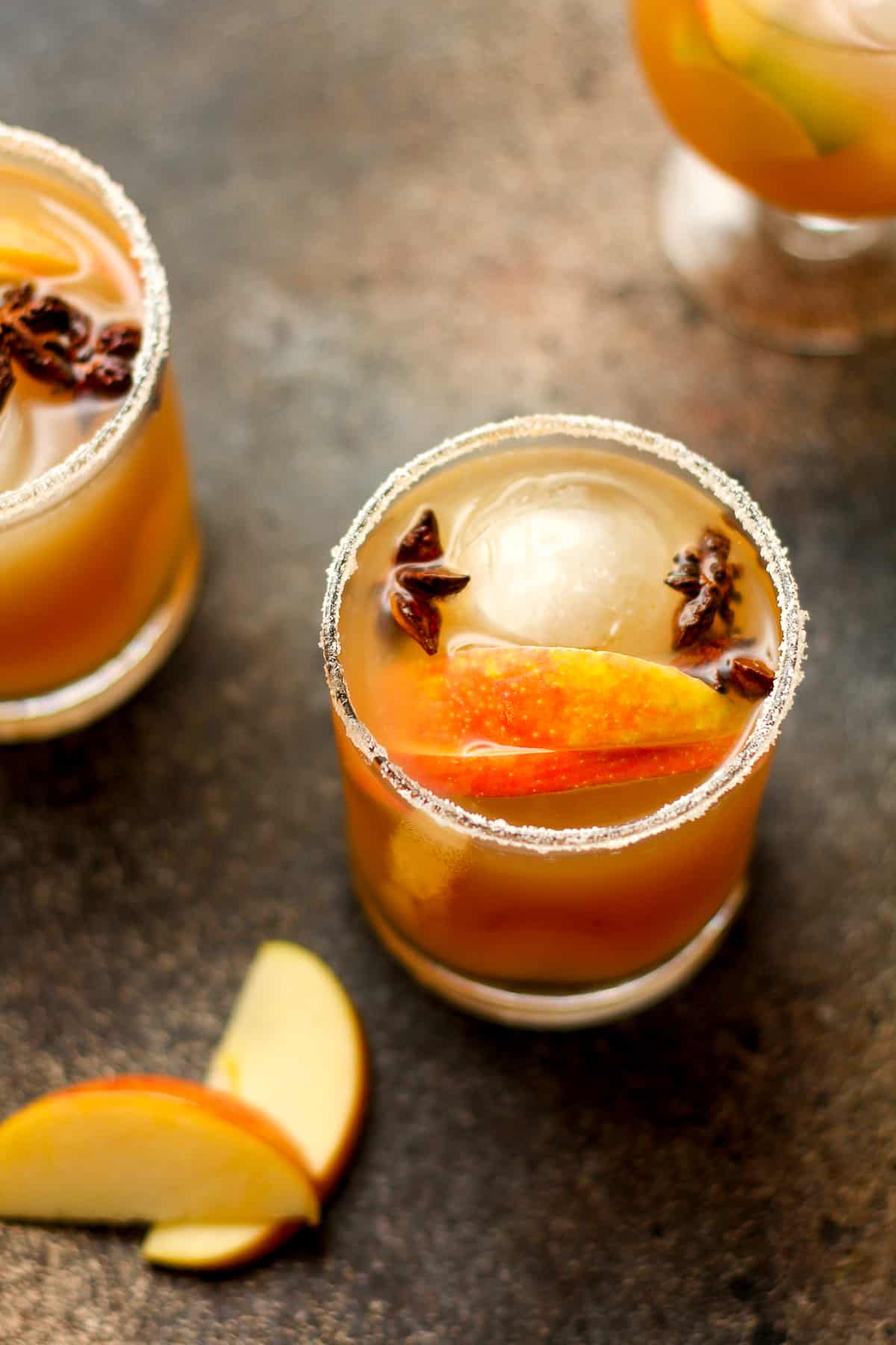 Apple cider margaritas with round ice cubes and star anise.
