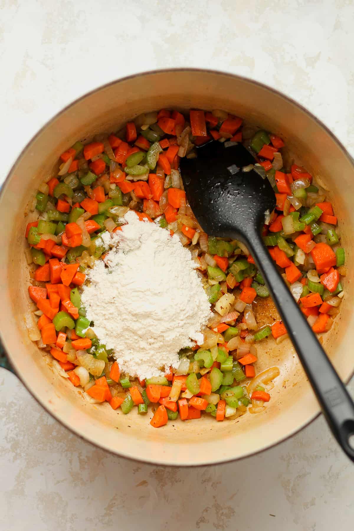 The pot of the sautéed veggies with flour on top.
