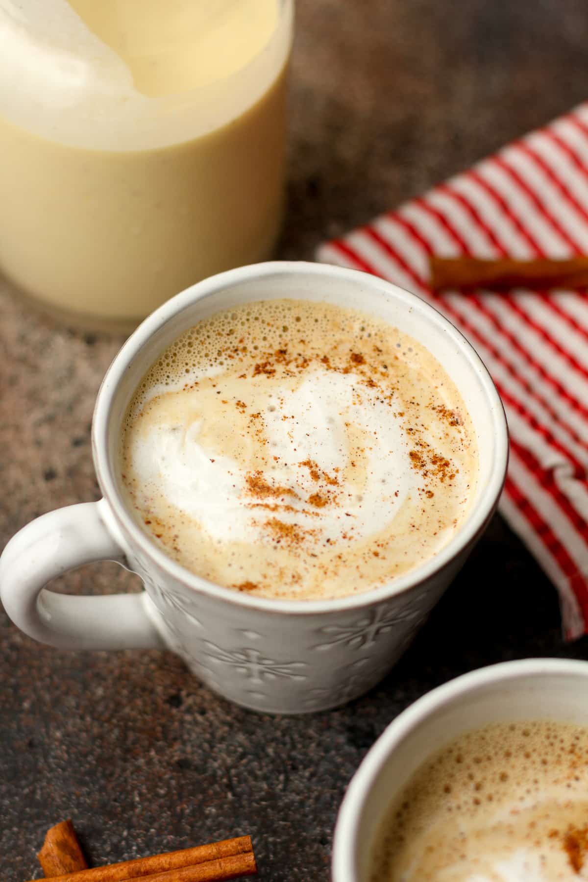 Side view of an eggnog latte in a white mug.