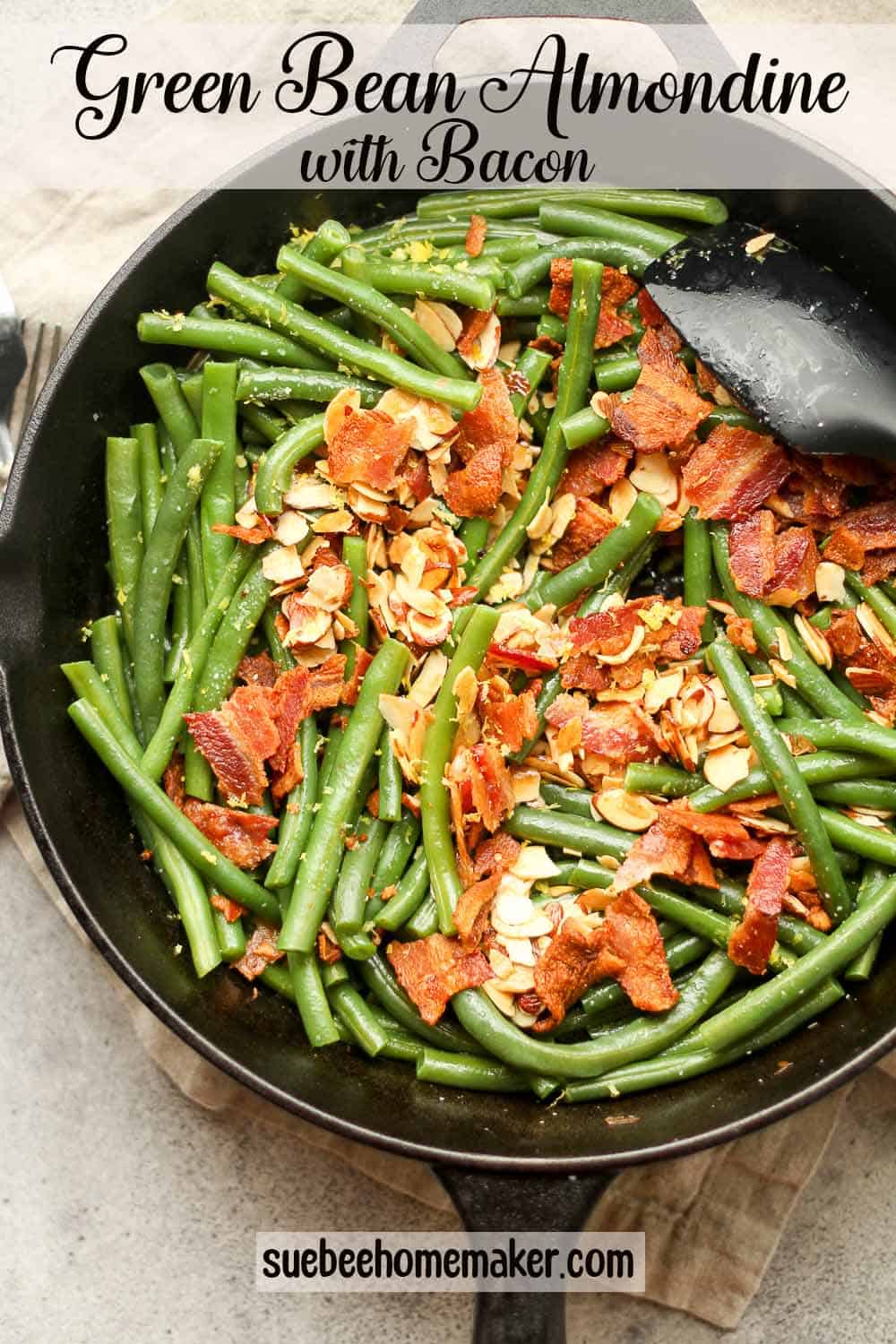 A skillet of green bean almandine with bacon.