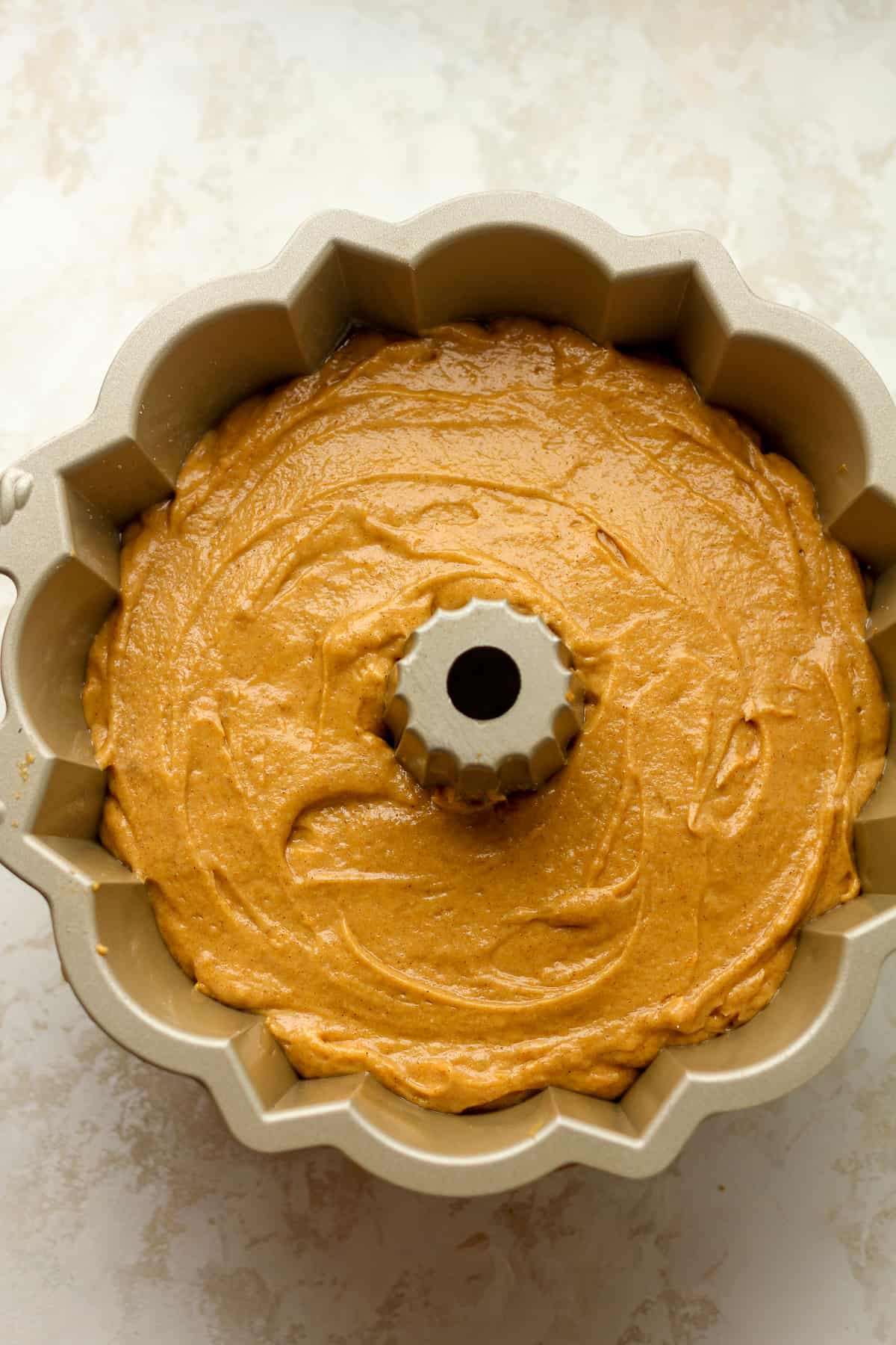The pumpkin bundt cake batter in a bundt pan.